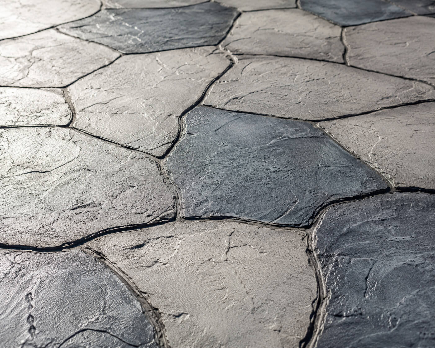 Gray stamped concrete patio and walkway overlay with an irregular flagstone pattern