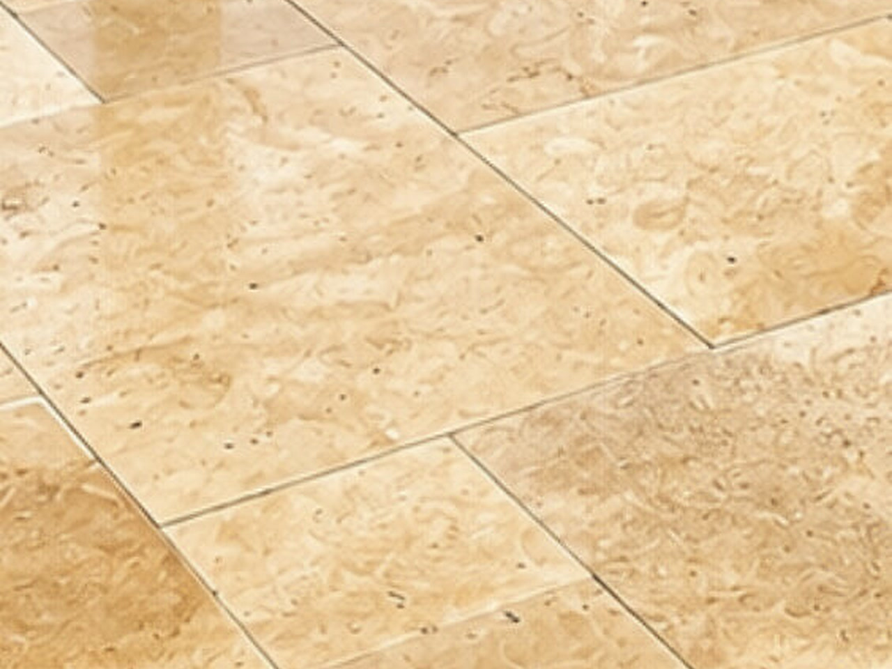 Close-up of ivory travertine pavers set in French pattern for a Boca Raton patio