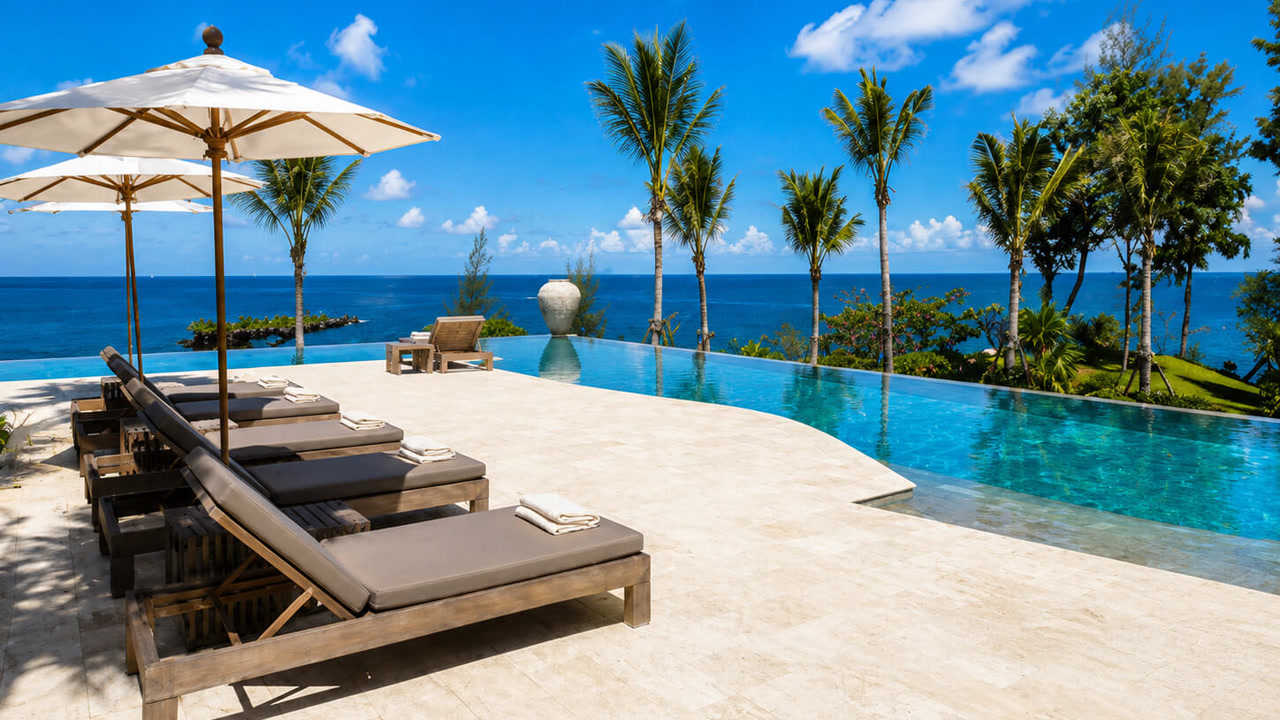 Renovated travertine paver pool deck around an infinity edge pool with an ocean view, completed for a Boca Raton homeowner